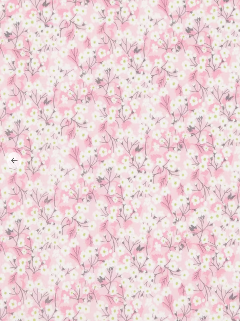 Floral pattern with small white flowers and green leaves on a pink background