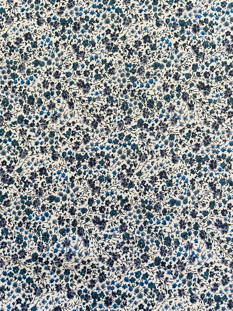 Floral pattern with small blue flowers on a white background