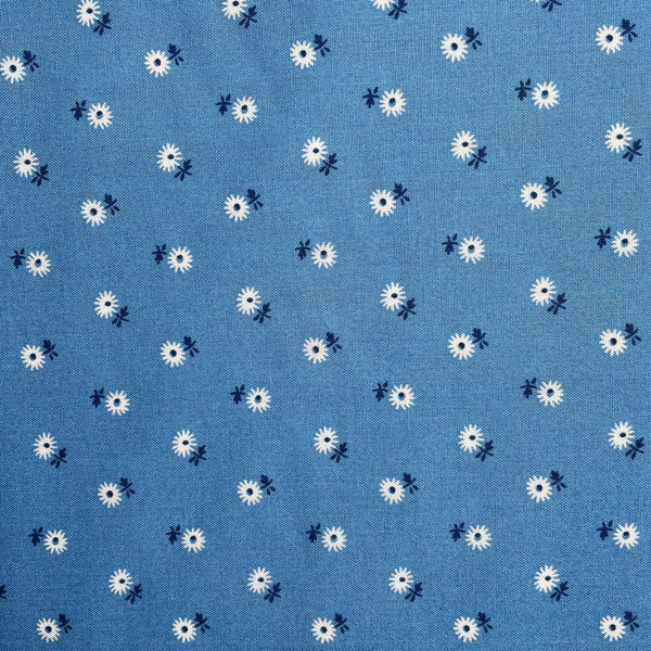 Pattern of white flowers with black centers on a blue background